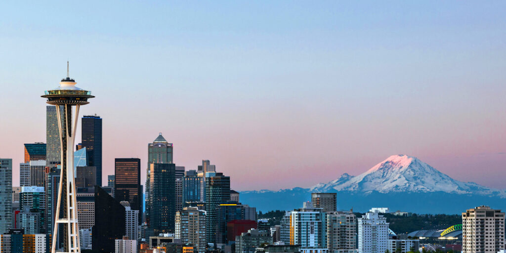 Seattle skyline with Space Needle and Mount Rainier at sunset